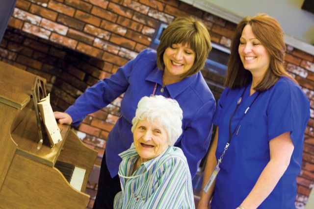 Two Long Term Care workers with a client